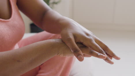 close up view of woman hands with moisturizing cream