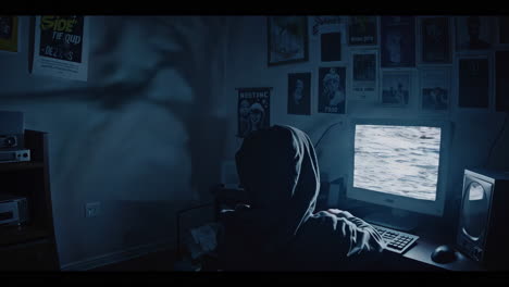 Person Working on a Computer in a Dark Room