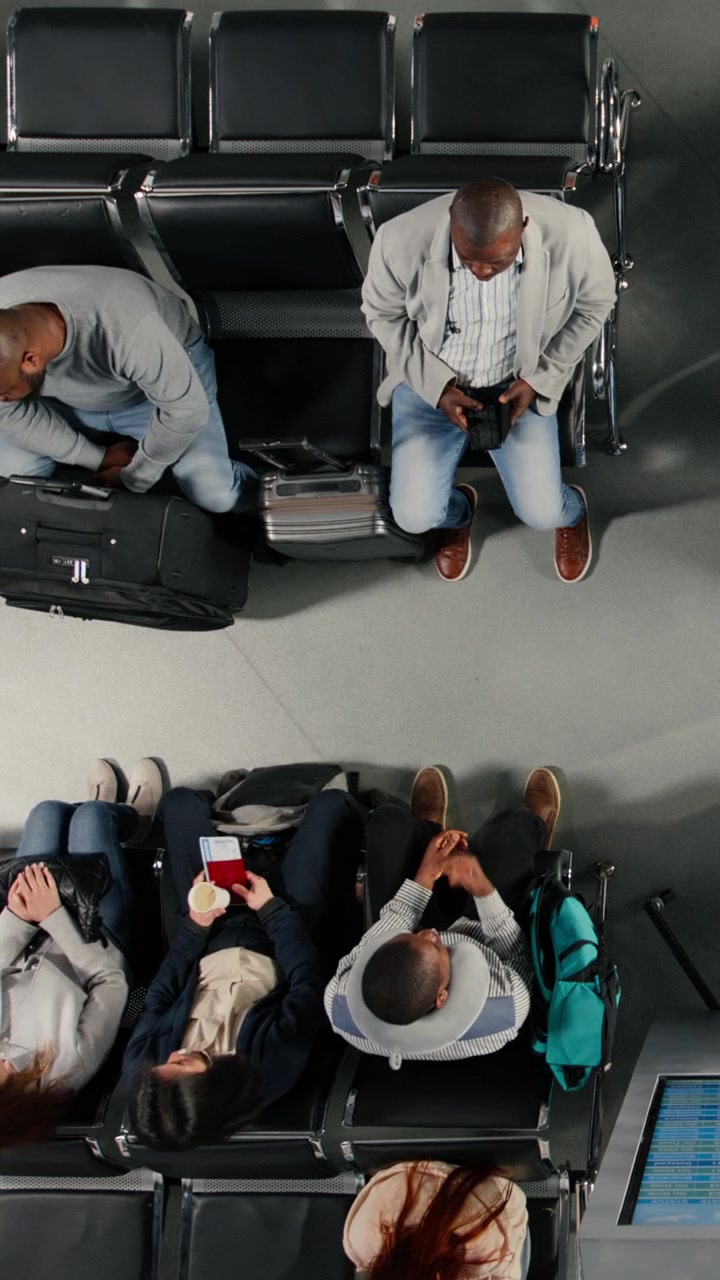 Overhead View of Diverse Travelers Waiting in Airport Lounge