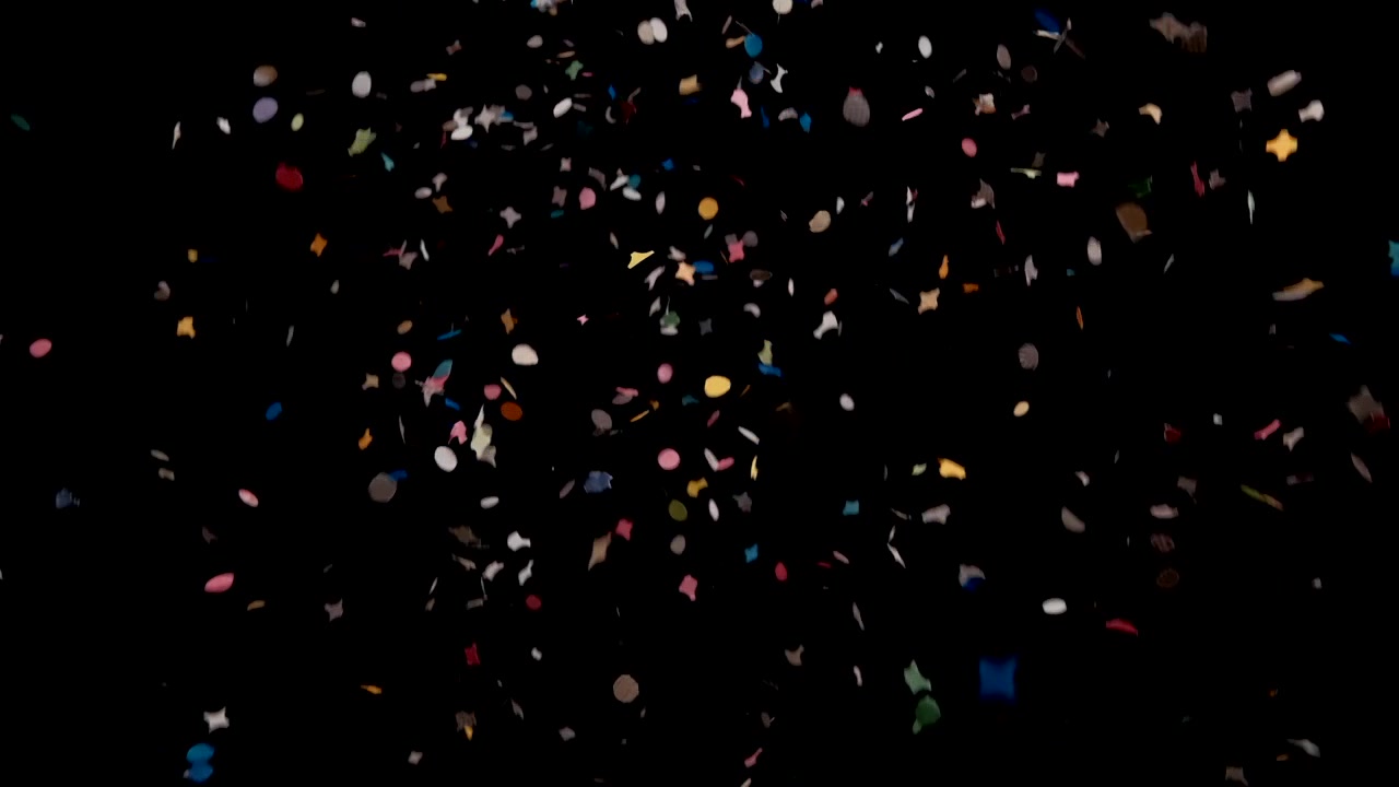 Esplosione colorata di coriandoli di Carnevale che cadono su sfondo nero