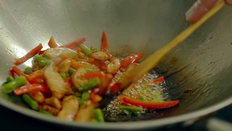 Cook-prepares-in-a-frying-pan-in-oil-with-fresh-vegetables---potatoes-tomatoes-green-beans