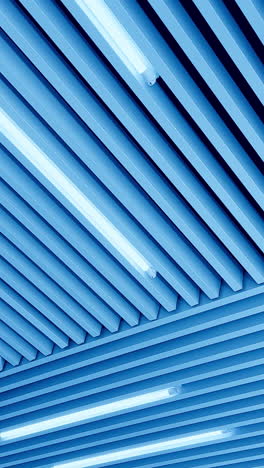 led lamps on the unusual ceiling. day light switched on. low angle view. vertical video