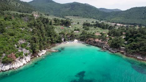 top down aerial view over glifoneri beach with white sand, turquoise water and lush vegetation, thassos island, greece, europe