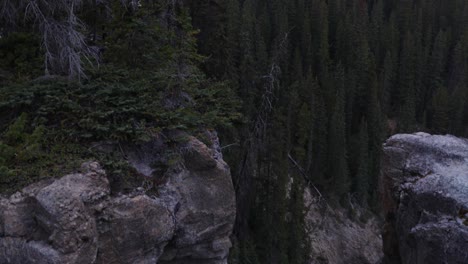 Water-pouring-through-a-shoot-on-the-side-of-a-mountain-in-Jasper-National-Park,-Alberta,-Canada