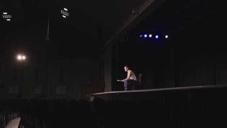 caucasian teenage boy in the high school auditorium preparing for a performance