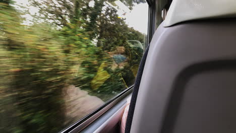 woman with reflection on the glass window wears facemask while travelling by train during covid-19 pandemic