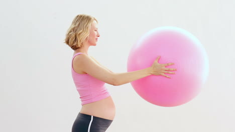 Pregnant-blonde-holding-exercise-ball