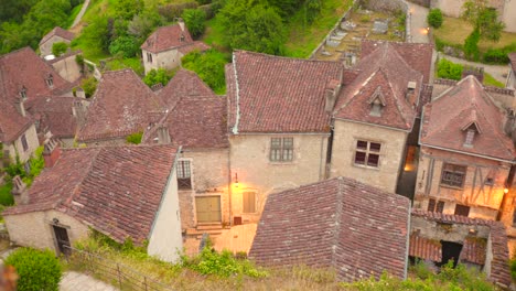 high angle view showing the reddish tiled rooftops and stone facades of saint-cirq lapopie, a charming historic village in france