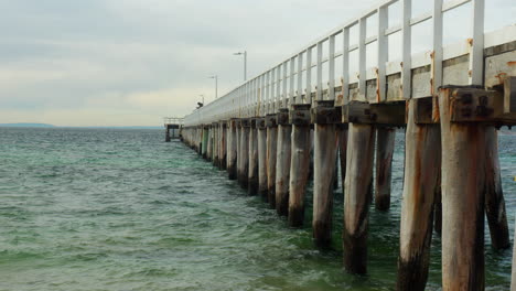 slow motion old wooden jetty on cloudy cold winters day