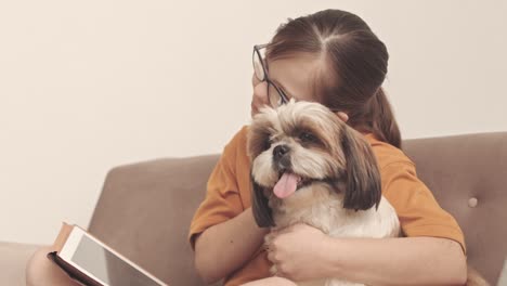 girl with down syndrome embracing dog at home