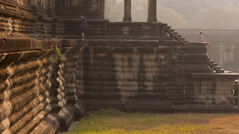 people walking on the ancient steps of angkor wat temple