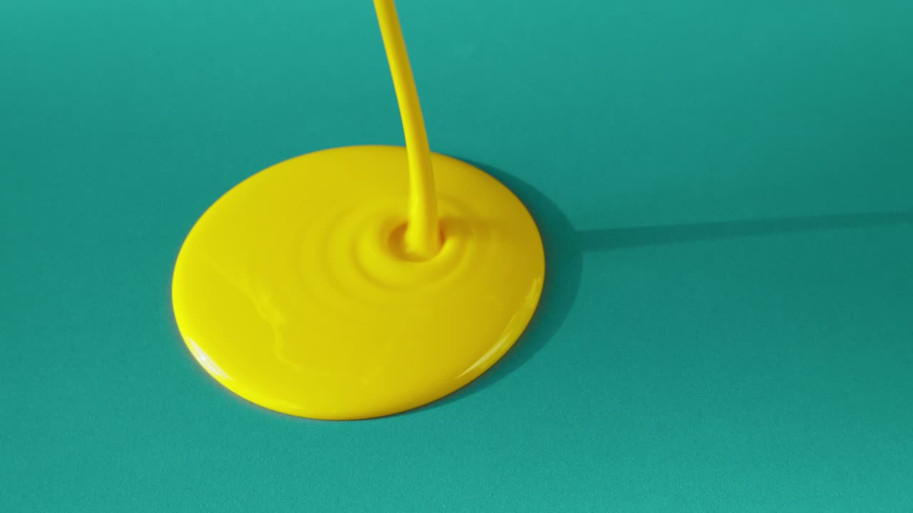 Yellow Paint Dripping on Teal Background