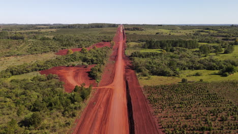 aerial view of a dirt road, winding through rustic terrain, showcasing the simplicity and charm of rural pathways