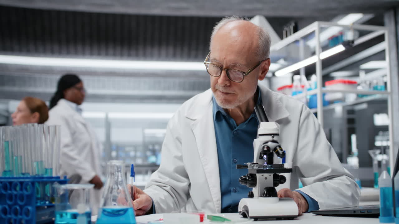 Laboratory scientist examining biopsy slide with microscope, logging results