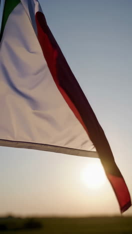 waving flags at sunset