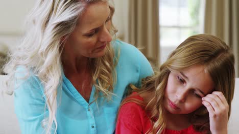 mother consoling her daughter in living room