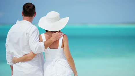 happy caucasian couple together on tropical vacation beach