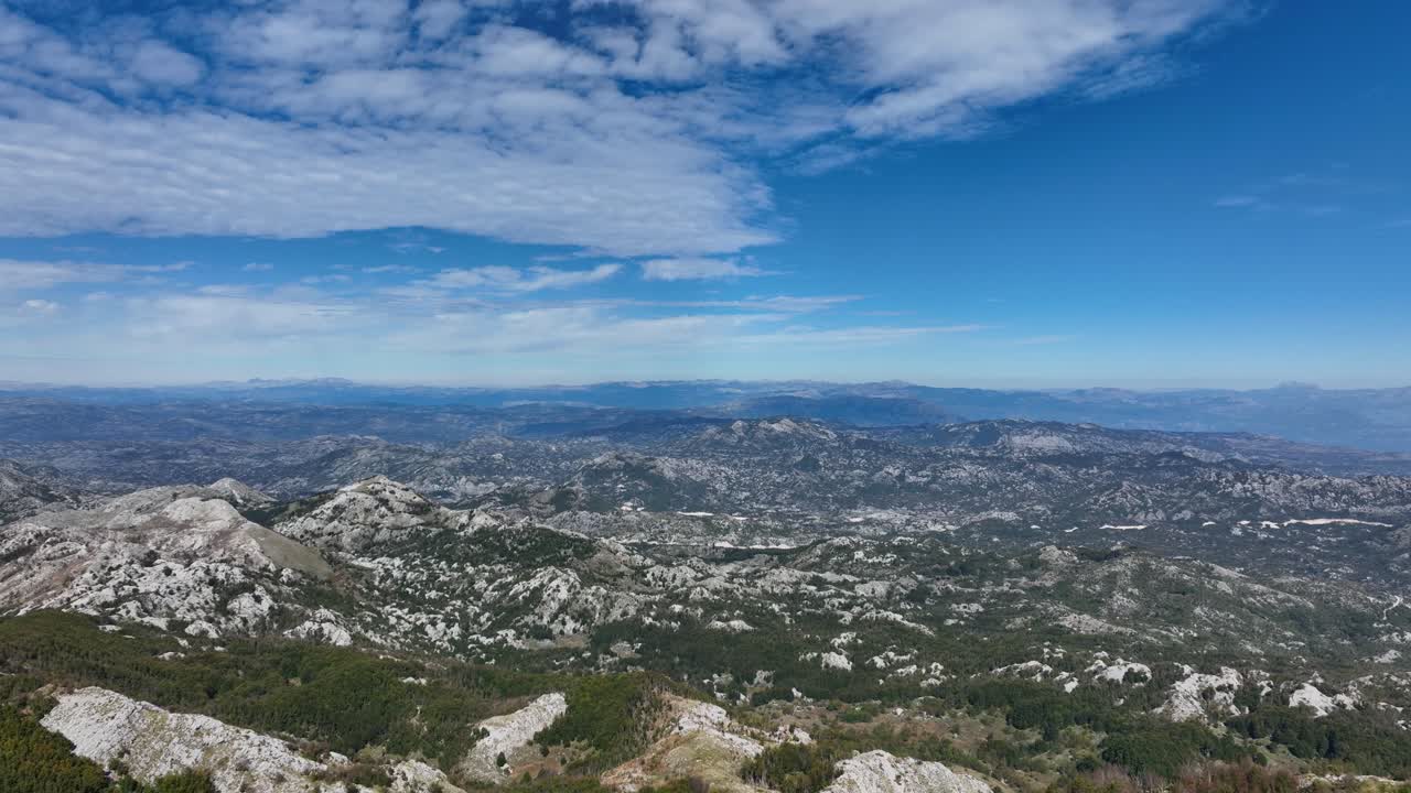 Flying Over The Trees And Revealing The Rocky Mountain Range Of Lovcen In Montenegro. - aerial shot
