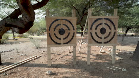 slow motion axe throw at target at manly tribal event for competition