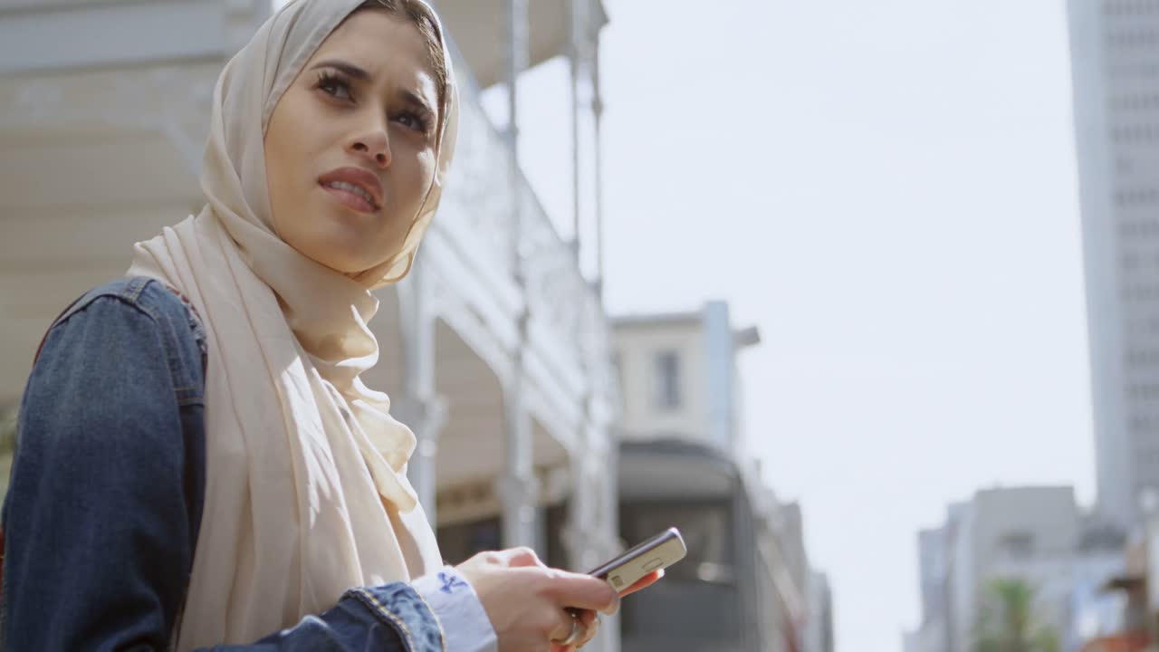 Woman in hijab using mobile phone 4k