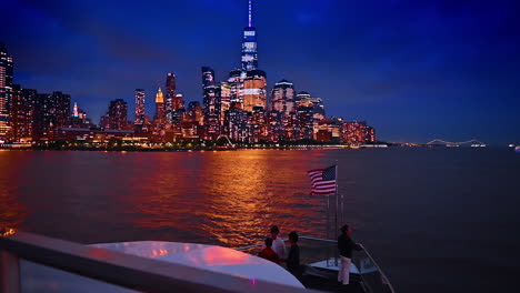 approaching the stunning luminous skyline of new york, usa at dusk time. river tour on board of the riverboat