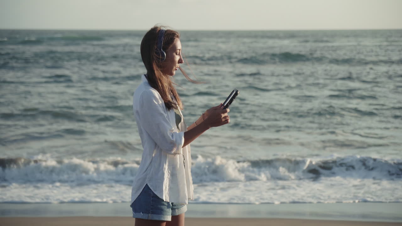 Woman with Tablet Standing by Ocean