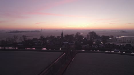 Wide-shot-of-rural-town-Tjerkwerd-Friesland-during-a-winter-morning,-aerial