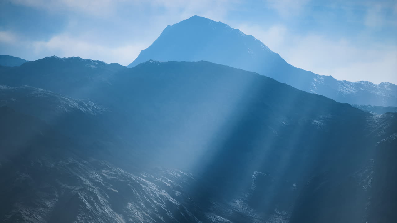 Majestic mountain peaks bathed in soft ethereal light during daytime