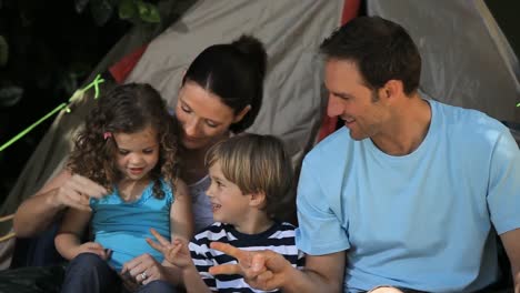 Family-palying-in-front-of-a-tent