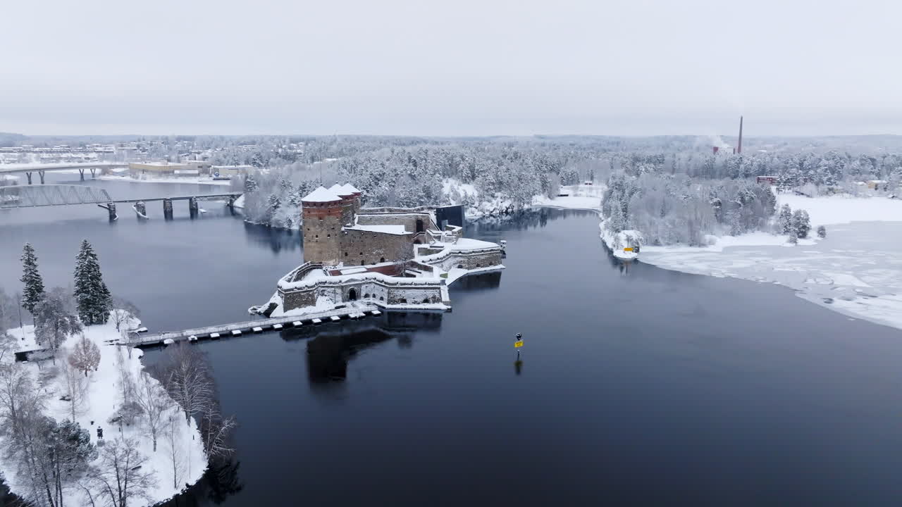 Panoramic drone shot around the Olavinlinna castle, winter in Savonlinna, Finland