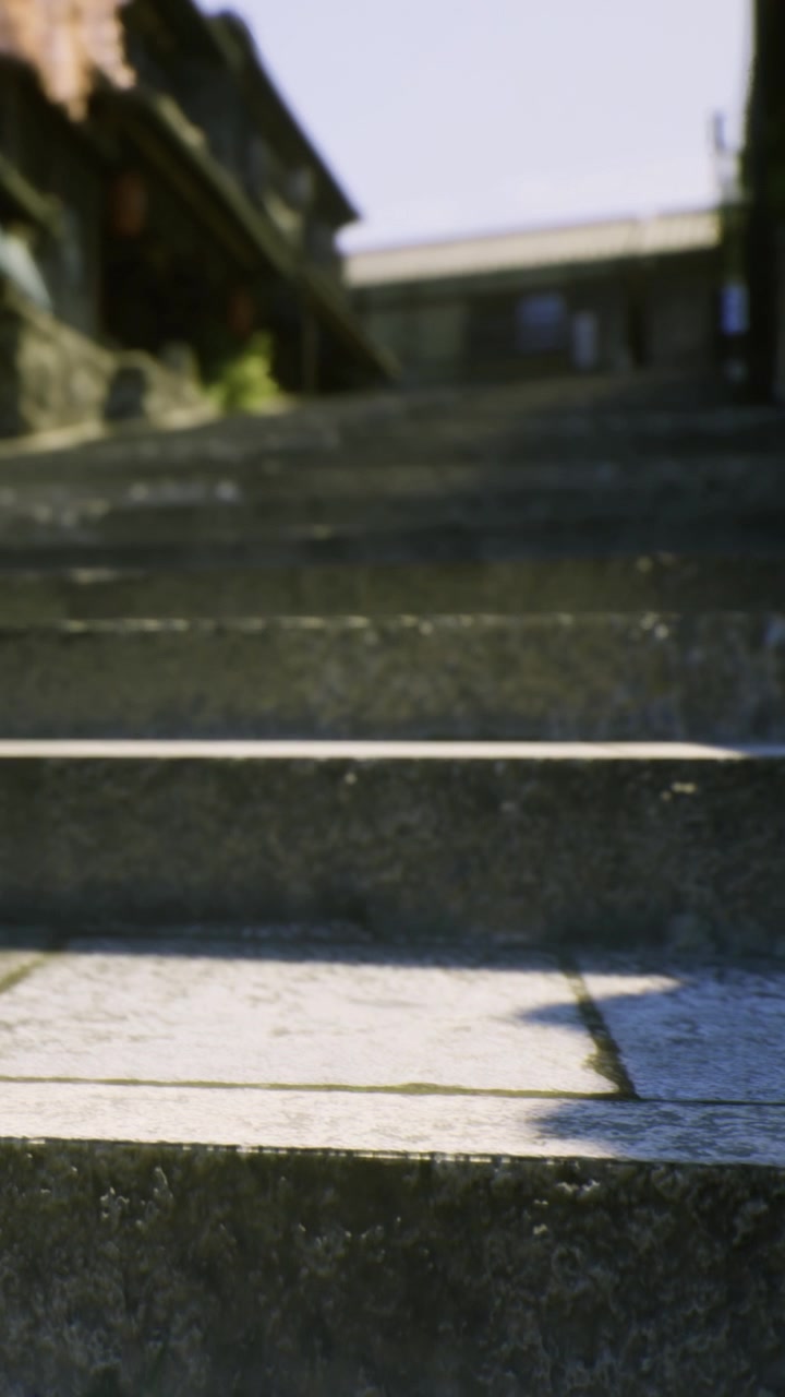 Steps lead to an entrance in a small town during daylight hours