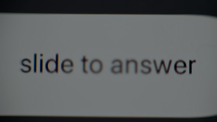 The simple process of sliding to answer an incoming call on a smartphone screen. Clear instructions and a close look at features are provided for better understanding