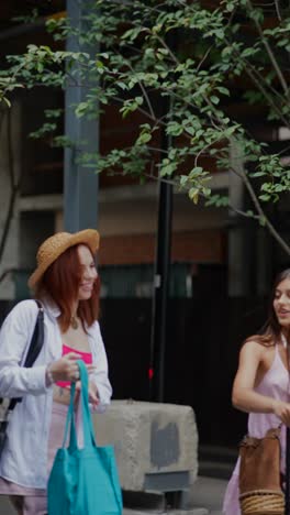 two women talking outdoors