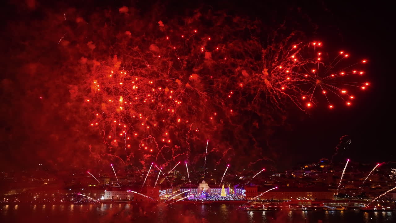 Panoramic drone shot of New Years eve fireworks on Tajo river, Lisbon, night