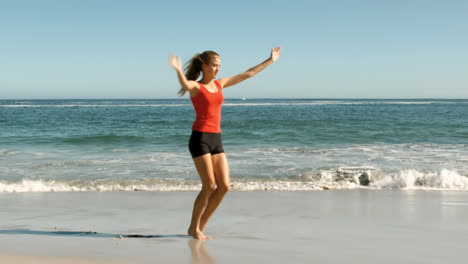 attractive woman doing cartwheels on the beach