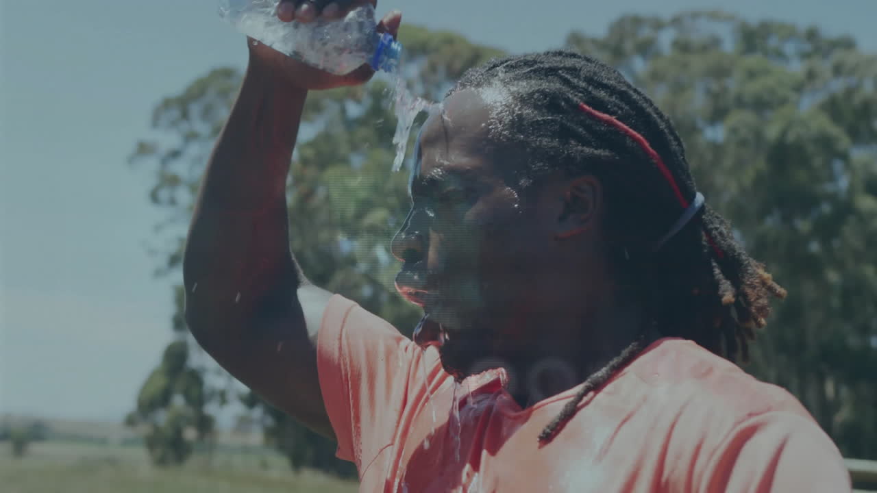 Pouring water over head, athlete cooling down after workout outdoors