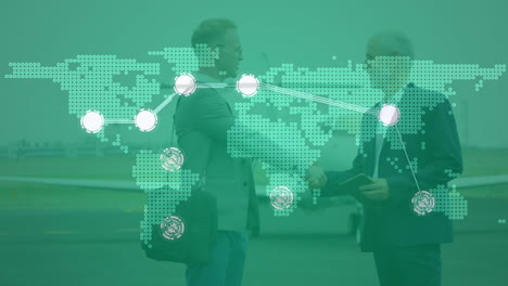 connecting dots over world map against two caucasian businessmen shaking hands at airport runway