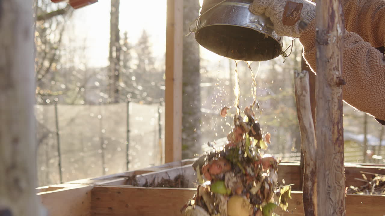 SLOW MOTION CLOSEUP, stunning shot of food waste bucket being emptied