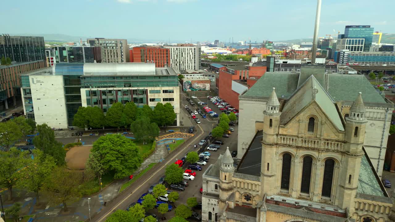 Side-on aerial video of St Anne's Cathedral in the Cathedral Quarter in Belfat City Centre, Northern Ireland on a bright and sunny day. Filmed in 4K, 60FPS and with Rec709 Color.