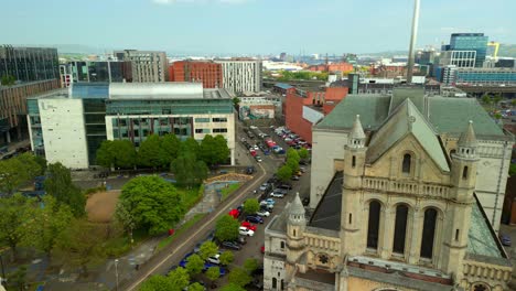 side-on aerial video of st anne's cathedral in the cathedral quarter in belfat city centre, northern ireland on a bright and sunny day. filmed in 4k, 60fps and with rec709 color.