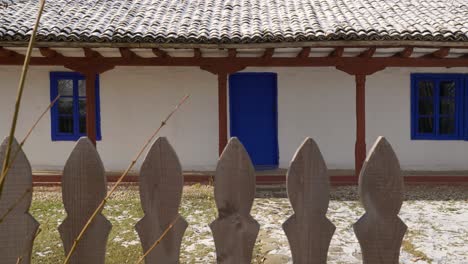 old house with blue entrance door and windows from 19th century