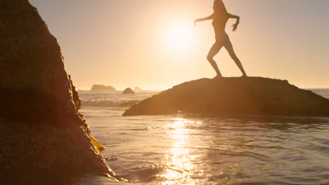 fit woman exercising in the beach 4k