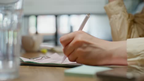 person taking notes in a meeting