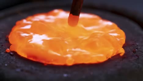 the transformation of molten metal: a journey from glowing orange liquid to solidified red matter captured in two stunning frames