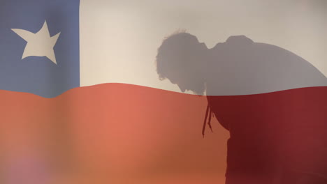 creating thoughtful scene, silhouette of person with chilean flag in background