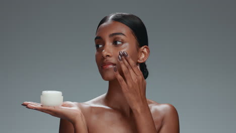 skincare, face cream and woman in studio