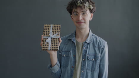 young man holding a gift