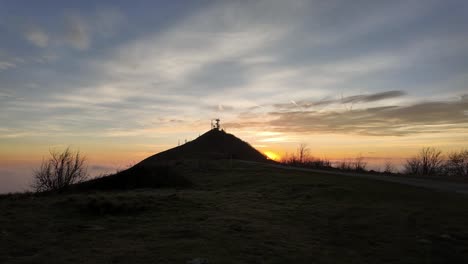 sunset over a hilly landscape in genoa with silhouettes of antennas, serene sky, italy, timelapse