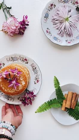 breakfast arrangement with flowers and decorative plates