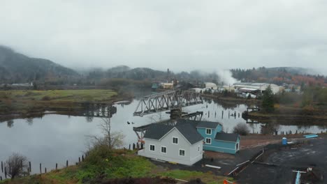 Aerial-view-of-old-swing-bridge-in-small-industrial-town-in-Washington,-USA